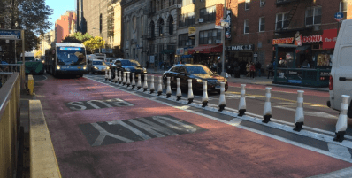 "Flexible bollards" at Sixth Avenue aim to keep motorists out of the way of buses. Photo: David Meyer