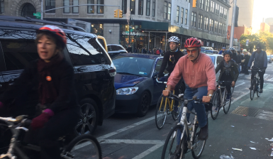 T.A. activists riding in the recently-inaugurated protected bike lane on Sixth Avenue. Photo: David Meyer
