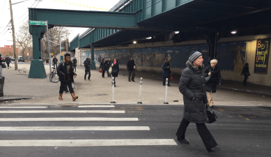 Commuters cross the newly car-free block of 15th Street on their walk to the subway entrance on Sheepshead Bay Road from the bus stop on Avenue Z. Photo: David Meyer