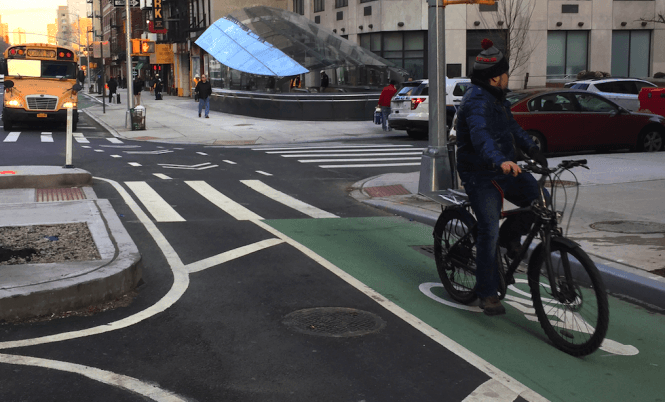 A cyclist passes by the 94th Street entrance to the soon-to-open Second Avenue Subway. Photos: David Meyer