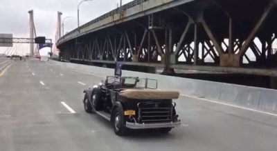 The governor celebrates his transportation infrastructure achievement by driving FDR's old car over the new Kosciuzsko Bridge. Imagery: @NYGovCuomo