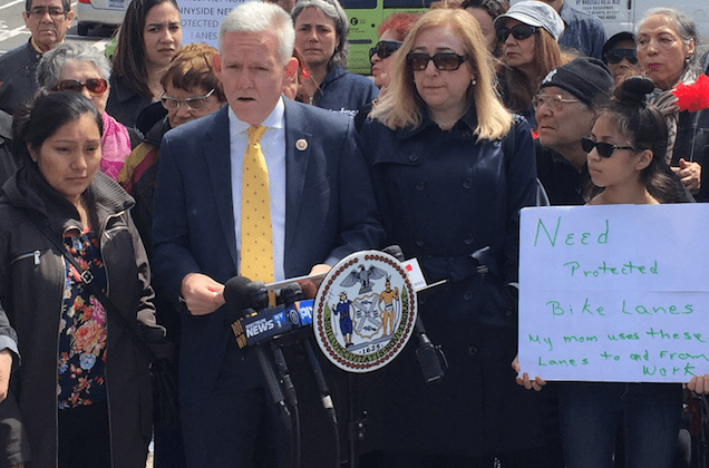 Jimmy Van Bramer, podium, in April speaking alongside CB 2 chair Denise Keehan-Smith, right, and Flor Jimenez, left, whose husband Gelacio Reyes was killed biking on 43rd Avenue. Photo: David Meyer