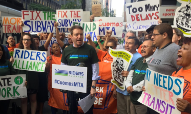 Riders Alliance Executive Director John Raskin and company outside Governor Cuomo's NYC offices last night. Photo: David Meyer