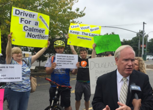 State Senator Tony Avella speaks to NY1 while flanked by supporters of the bike lane he opposes. Photo: David Meyer