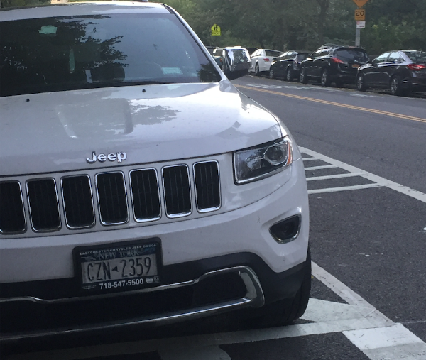 DOT says it's up to NYPD to keep placard holders from parking in this crosswalk, where an NYPD placard-holder was parked Tuesday.