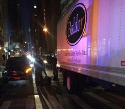 A truck driver hit a cyclist after the driver of a Mercedes SUV, pictured at left, doored him on 29th Street near Eighth Avenue. Photo: Lisa Sladkus