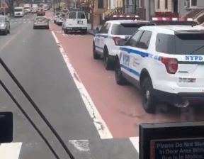 Police vehicles parked in the Utica Avenue bus lane. Via TransitCenter