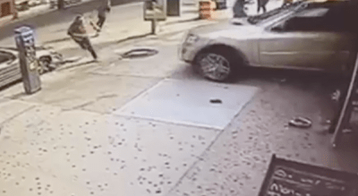 People on the sidewalk scatter as Kwasi Oduro accelerates forward after backing into a restaurant and running over 7-year-old Ethan Villavicencio. Video still: News 12