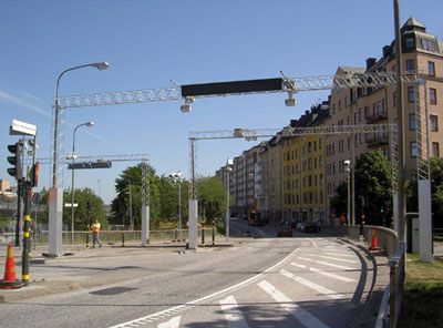 Oh no, the costly bureaucracy. Photo of Stockholm congestion toll gantry via FHWA