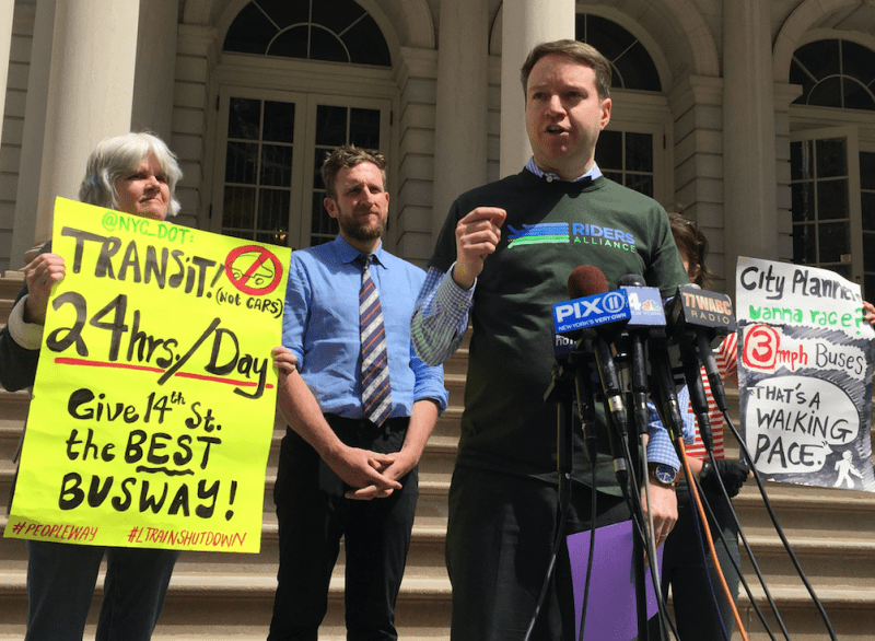 Riders Alliance director John Raskin speaks outside City Hall this afternoon. Photo: David Meyer