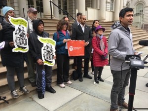 Council members Carlos Menchaca and Margaret Chin (background right) with delivery worker advocates at City Hall yesterday. Photo: Brad Aaron
