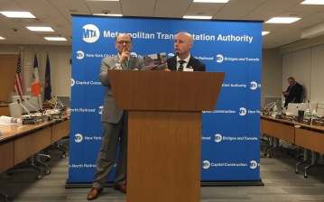 New York City Transit President Andy Byford holds up a copy of his "Fast Forward" plan to fix the subways and buses. Photo: David Meyer
