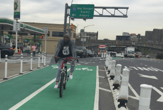 Buget money could mean more protected bike lanes, such as this one on the Madison Avenue Bridge from the Bronx. File photo: David Meyer