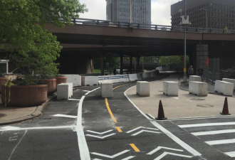 The new Park Row protected bike lane, facing east from Frankfort Street. Photo: Wiley Norvell/Twitter
