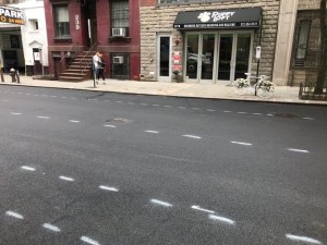 Painted markings for 26th Street's forthcoming protected bike lane adjacent to the memorial bike for Dan Hanegby, killed biking there last June. Photo: Twitter/Jeff Novich