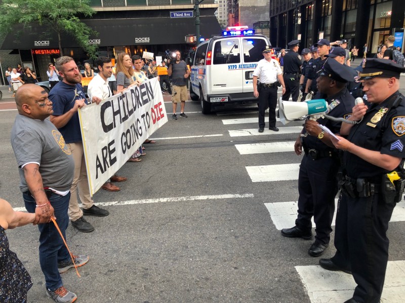 Raul Ampuero, far left, was arrested for disorderly conduct along with eight other protesters demanding a special legislative session to renew and expand NYC's speed camera program. A hit-and-run driver killed Raul's son Giovanni, 9, on Northern Boulevard this spring. Photo: Ben Fried