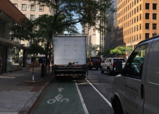 Without anything to keep cars out, the Midtown section of the Second Avenue bike lane often looks like this during rush hour. Photo: Macartney Morris