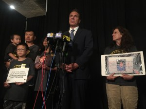 Governor Cuomo speaking to reporters alongside members of Families for Safe Streets. Photo: David Meyer