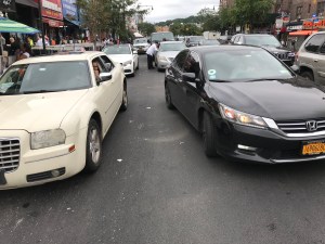 Dangerously double-parked cars like this will continue to clog streets if the NYPD is forced to close its Manhattan tow pound. Photo: Ben Jay