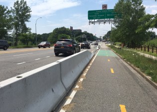 The city installed this really good bike lane to protect cyclists along a dangerous stretch of Northern Boulevard, but the local community board keeps meeting in secret to undermine it. Photo: Laura Shepard