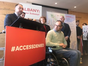 Last year, Council Speaker Corey Johnson (at podium with disabled advocate Sasha Blair-Goldenshon in the foreground) said he supported better subway accessibility. Not much has changed in the 18 months since this photo was taken.