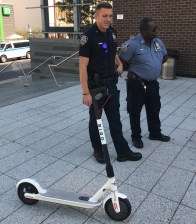 Two cops check out a Bird scooter at an event over the summer. Photo: Gersh Kuntzman