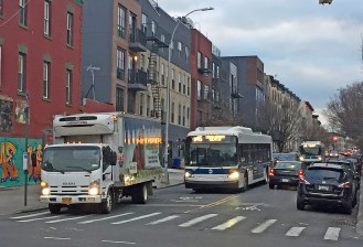 Two buses back-up behind a delivery vehicle parked in the bus stop along narrow St. Johns Place. File photo: Isaac Blasenstein