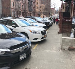 The car that got slapped with 63 tickets, including 34 speeding tickets and seven red light tickets, is parked in the foreground of the general mess at the 23rd station house in East Harlem. Photo: Julianne Cuba