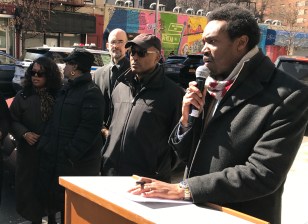 Community Board 9 Chairman Padmore John (at podium) said last month that the board would not support a DOT plan to make Amsterdam Avenue safer as (from right) Victor Edwards, Martin Wallace and Carolyn Thompson look on. Photo: Gersh Kuntzman