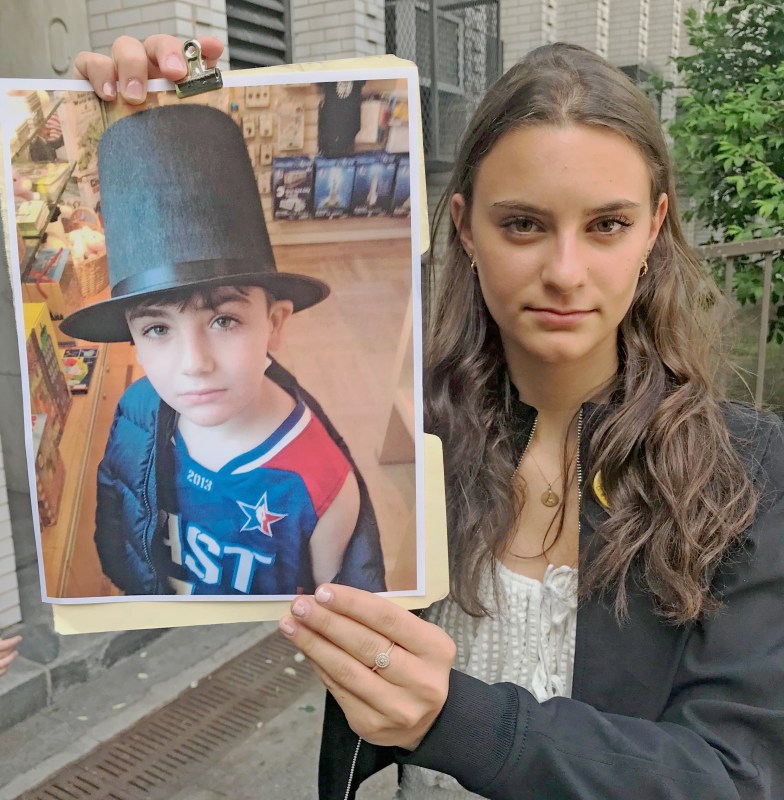 Truth to power: Avery Dermer held a photo of her childhood friend Cooper Stock when she called on the mayor for more action on street safety. Photo: Julianne Cuba
