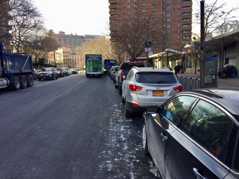 Cars frequently reclaim protected bike lanes — as they did on the two-way stretch of Clinton Street on the Lower East Side — between the time the DOT removes pavement and when the agency restores painted markings. Photo: Jon Orcutt