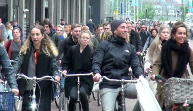 Happy smiling (Dutch) people riding bikes. Photo: Clarence Eckerson Jr.