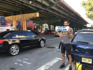 Mirza Molberg holds a sign reminding drivers that they killed another person on Third Avenue on Monday. Photo: Ben Kuntzman