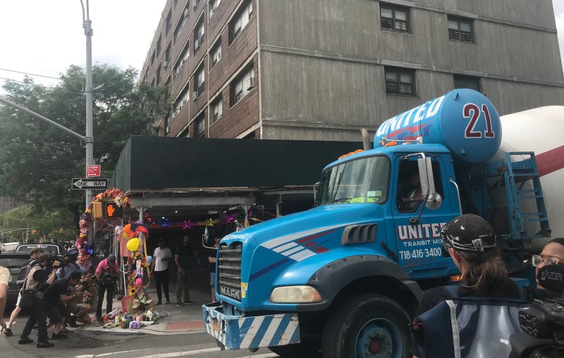 Cement trucks from the same company whose driver killed Devra Freelander in Bushwick on Monday continued to roll past the site on Wednesday as activists mourned (background). Photo: Julianne Cuba