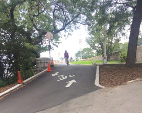 A cyclist approaches the slope on part of the bypass bike path in Riverside Park.
