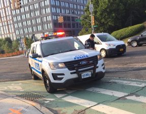 An officer prepares to issue cyclist Alan Mukamal a ticket while parked in the the bike lane at the corner of Atlantic Avenue and Furman Street in Brooklyn. Photo: Alan Mukamal