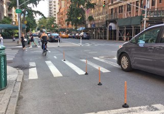 Members of the Transformation Department put out plungers on Fifth Avenue to demonstrate the danger of unprotected mixing zones. Photo: Transformation Department