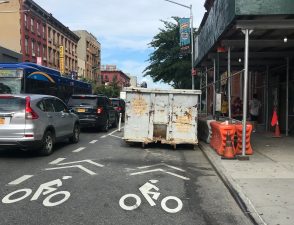 A dumpster in the bike lane on Grand Street this summer. Photo: Julianne Cuba.