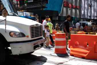 A truck crashes into a traffic drum on 43rd Street and Broadway in Manhattan in 2019. As the truck reverses, a child looks on. The next Manhattan district attorney will have a huge role in determining how the city responds to traffic violence.