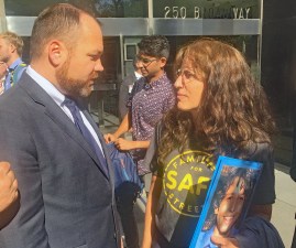 Council Speaker Corey Johnson chats with Families for Safe Streets advocate Amy Cohen, holding a picture of her son, Sammy, who was killed by a driver. Photo: Gersh Kuntzman