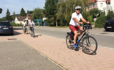 Real bike lanes, and legal e-bikes, encourage German cyclists like these to reduce car trips.