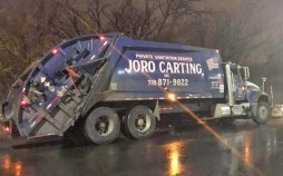 Above, a private carting truck that lacks protective side rails. The city's historical deal on commercial waste zones will mandate the rails — if it ever gets off the ground. Photo: Facebook