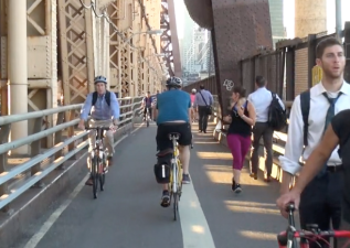 Pedestrians and cyclists going east and west on the Queensboro Bridge share a narrow path. Photo: Clarence Eckerson Jr.
