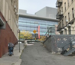 This portion of dead-end step street Coles Lane could have been transformed into a public plaza to create an inviting gateway to the $50-million Bronx library on E. Kingsbridge Road (background), but city rules made that impossible. Photo: Janet Liff