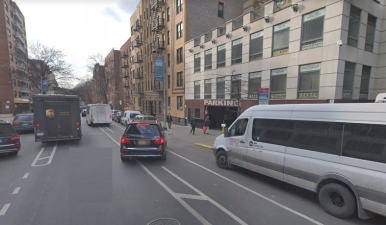 This is a common scene on Sanford Avenue: A double-parked truck (left) and a big van obscuring pedestrians on the sidewalk as a car driver pulls into a garage. The only way to ensure pedestrian safety in Flushing is to dramatically restrict motorized vehicles. Photo: Google