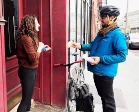 Very special delivery! Bartender Tom Roughton (right) drops a fresh cocktail off to grateful customer Victoria Rosner (left). Photo: Dave Colon