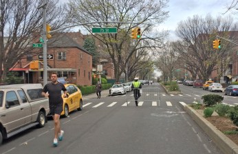 A Queens jogger socially distances himself from his neighbors, thanks to the mayor's open-streets program, which ended Sunday and will not be continued. Photo: Angela Stach