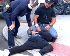 A cop in the East Village kneeled on a man arrested for alleged social-distancing violations. Video showed that the officer punched the man while tackling him. Photo: Daquan Owens