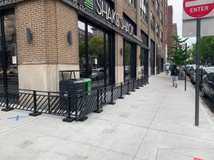 Shake Shack has pulled in its metal railings so they are finally inside the restaurant's property line. Photo: Gersh Kuntzman