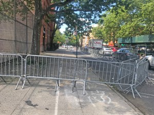 The 88th Precinct has stolen the sidewalk in front of the Classon Avenue station house, forcing pedestrians into the street. Photo: Dave Colon